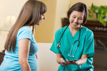 Health-care practitioner and pregnant individual talking